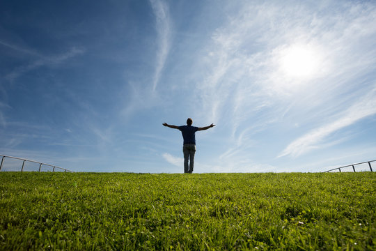 man standing on grass in sunlight