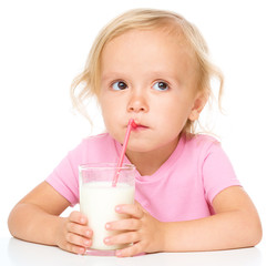 Cute little girl with a glass of milk
