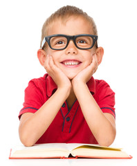 Little boy is reading a book