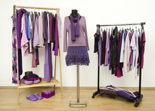 Wardrobe With Purple Clothes On Hangers And Outfit On Mannequin.