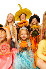 Girl with pumpkin, friends in Halloween costume