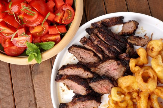 Flank Steak With Fries Onion Rings And Salad