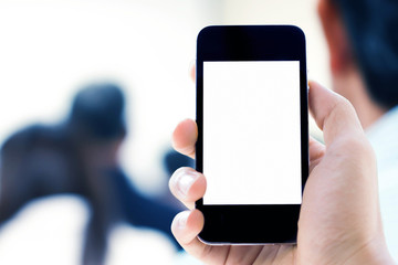 Close up of hands man using his cell phone,blurred background