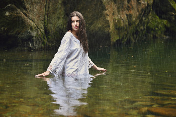 Beautiful woman in forest stream