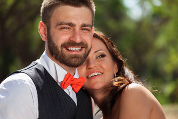 European bride and groom kissing in the park