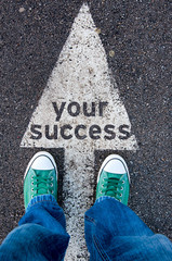 Green shoes standing on your success sign