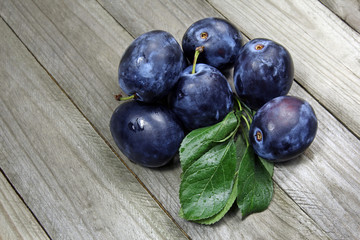 fresh plums on wooden table