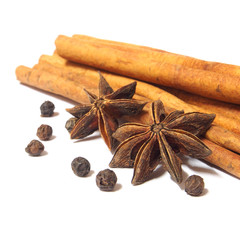 Cinnamon sticks and anise stars isolated on white background