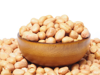 Dried peanut in wooden bowl isolated on white background