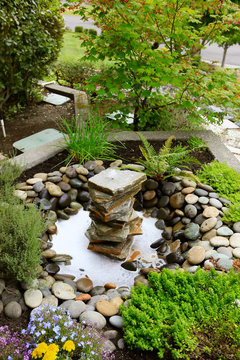 Ideas for landscaping home garden. Fountain with rocks
