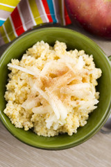 Portion of sweet millet porridge with apple and cinnamon