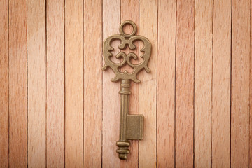 Old key on a wooden background