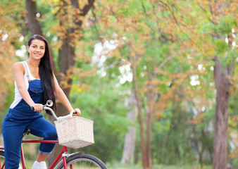 Teen girl on a bicycle in the park.