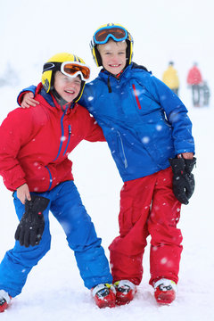 Two happy boys enjoying skiing