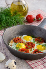 Breakfast with fried quail eggs with cherry tomatoes