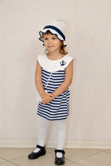 The little cheerful girl in a striped dress and the Panamanian