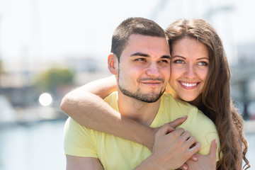 Fototapeta premium Couple taking sunbath on the pier