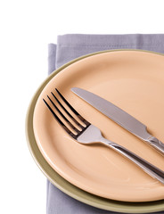Plates with silverware on gray napkin
