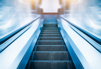 Empty escalator or moving stair. Also called stairway or staircase. Modern architecture design with step, glass for lift people up floor building i.e. shopping mall, airport, metro and subway station.