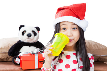 smiling girl in santa helper hat with teddy bear