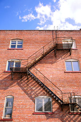 Fototapeta na wymiar fire escape ladder and brickwall