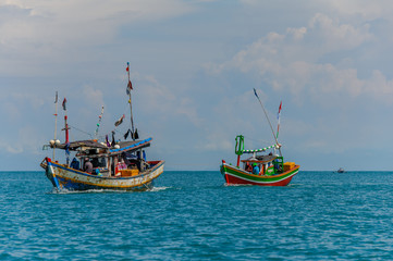 Indonesian fishermen on the colorful fishing boats in the sea