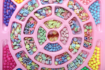 Multicoloured beading kit for children in a pink box