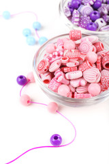 Beads in glass bowls isolated on white
