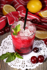 Fresh cold cherry cocktail with mint, ice and lemon