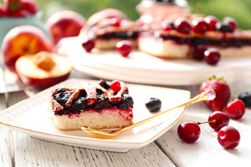Sweet berry tart with berries on wooden table close-up