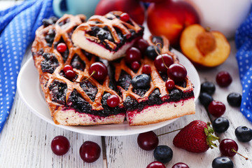 Sweet berry tart with berries on wooden table close-up