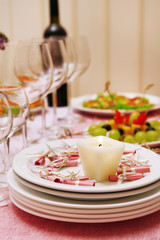 Buffet table with dishware and candle waiting for guests