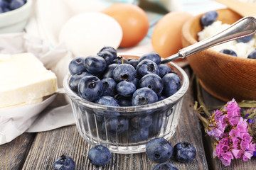 Fresh blueberries and milk products on wooden table