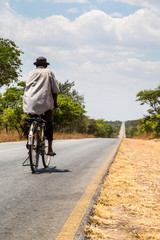 Local man riding on a bike on a desolated road