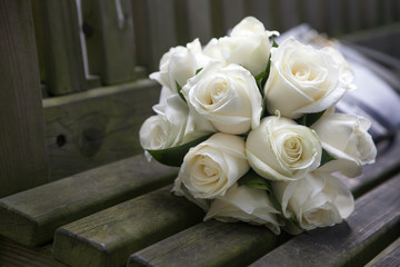 Wedding roses bouquet on wooden bench