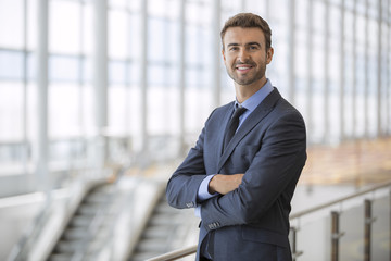 Portrait of happy businessman at an airport terminal