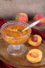 tasty apricot jam with fresh apricots on wooden table