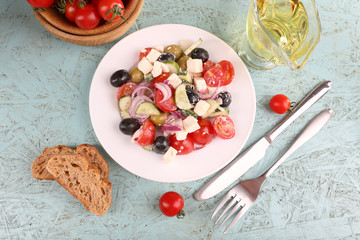Greek salad in plate on wooden background