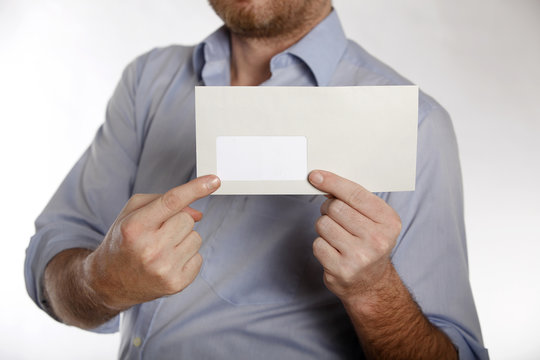Man holds a letter into the camera