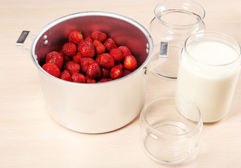 Cooking delicious strawberry jam in kitchen