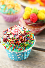 Delicious birthday cupcakes on table close-up