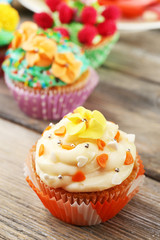 Delicious birthday cupcakes on table close-up