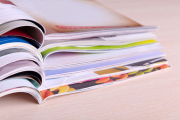 Magazines on wooden table close up