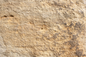 Rough rock background texture with orange and gray tints