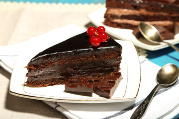 Chocolate cakes  on plates, on color wooden background