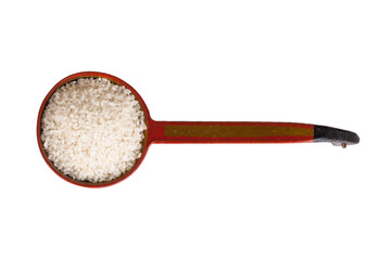 round Kuban rice in an old wooden ladle isolated on white backgr