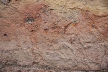 Rough rock background texture with orange and slight pink tints