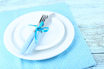 White plates, fork, knife and Christmas decoration
