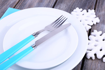 White plates, fork, knife and Christmas tree decoration