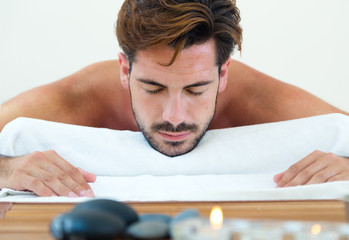 Masseur doing massage on man body in the spa salon.